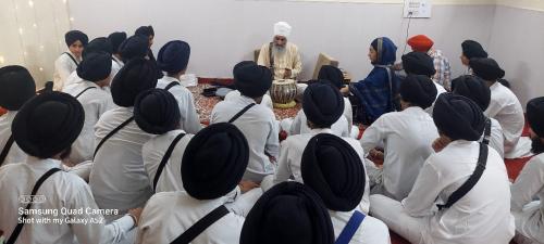 Principal Sukhwant Singh Ji teaching Gurmat Sangeet Lessons to students  in the workshop